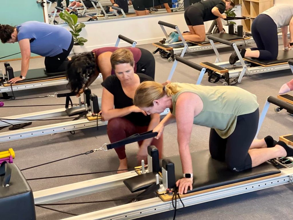 On the Green Reformer Pilates class