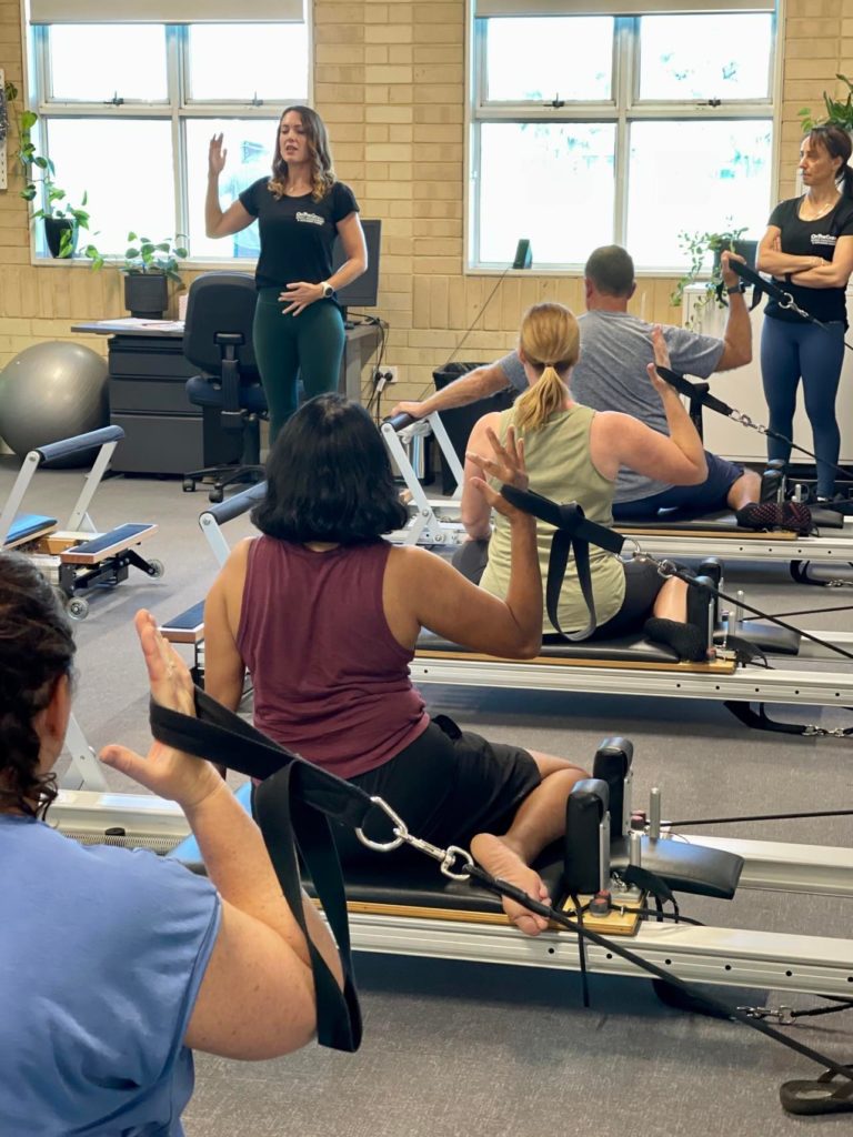 On the Green Reformer Pilates class